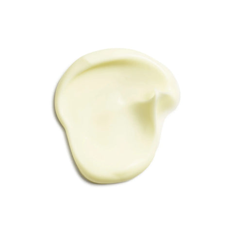 A smooth, pale yellow dab of moisturizing face cream rests against a clean white background.